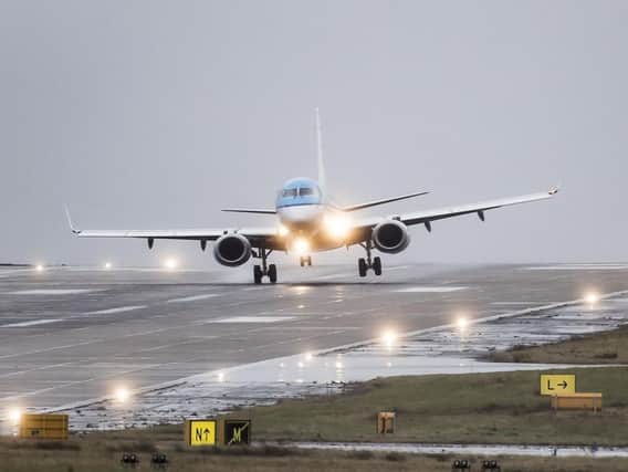 Plane landing at Leeds Bradford Airport. (Credit: PA)