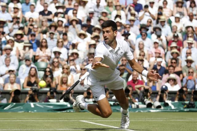 Novak Djokovic dives to his left in his match against Roberto Bautista Agut. Picture: Carl Recine/PA