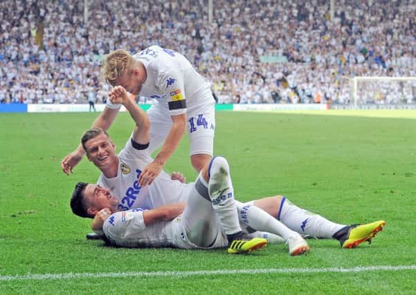 PERFECT START: Pablo Hernandez celebrates Leeds United's second goal against Stoke on the opening day of last season with team-mates Samuel Saiz and Liam Cooper. Picture: Tony Johnson..