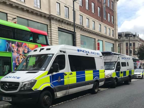 Police vans on the Headrow on Saturday.