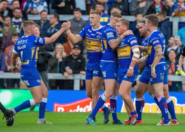 Brad Dwyer celebrates Leeds Rhinos' first try against Hull KR with Ash Handley.