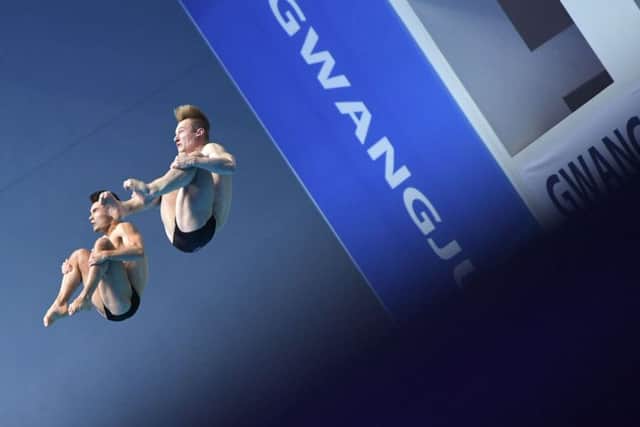 In sync: Jack Laugher and Dan Goodfellow en route to winning their silver medals. (Pictures: MANAN VATSYAYANA/AFP/Getty Images)