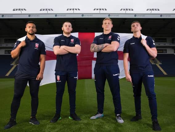 England Knights players Kruise Leeming, Cameron Smith, Mikolaj Oledzki and Jack Walker fly the English flag at Headingley.