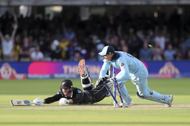 THAT WINNING MOMENT: England's Jos Buttler runs out New Zealand's Martin Guptill to clinch a dramatic victory at Lord's and clinch the country;s first-ever World Cup. Picture: AP/Aijaz Rahi