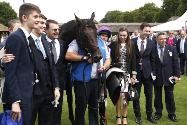 Jockey Ryan Moore (centre right) with horse Ten Sovereigns and trainer Aiden O'Brien (third left).