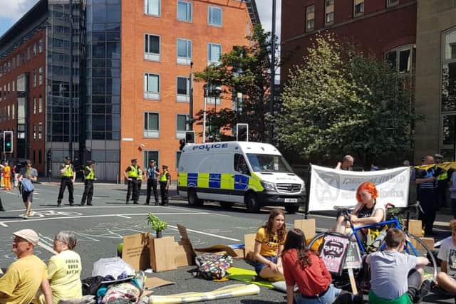 Protesters 'sitting in' to block the road.