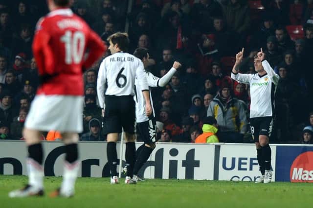PROUD MOMENT: Wayne Rooney is left with hands on hips as Pablo Hernandez, right, celebrates scoring for Valencia during the UEFA Champions League Group C clash and 1-1 draw against Manchester United at Old Trafford on December 7, 2010. PICTURE BY PAUL ELLIS/AFP/Getty Images.