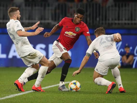 TOO GOOD: Manchester United's England international Marcus Rashford prepares to beat Leeds United duo Stuart Dallas and Gaetano Berardi before doubling his side's lead in Perth. Picture by Paul Kane/Getty Images.