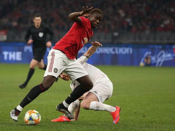 DIFFERENT CLASS: Manchester United's World Cup winner Paul Pogba takes on Leeds United midfielder Adam Forshaw. Picture by Paul Kane/Getty Images.