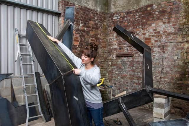 Pictured Rebecca Appleby, working on a new sculpture for Kirkstall.
