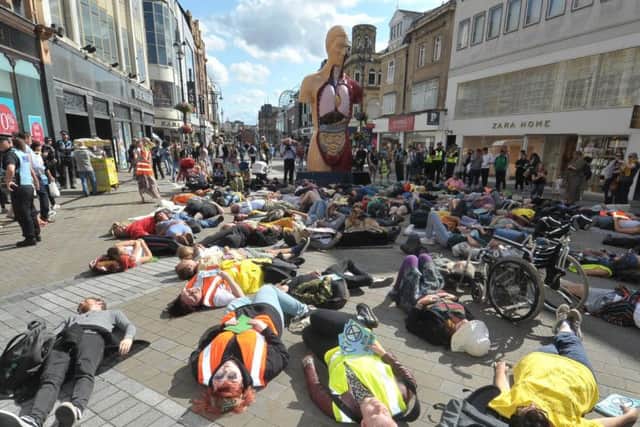 Extinction Rebellion protesters staging a mass 'die-in' on Briggate.