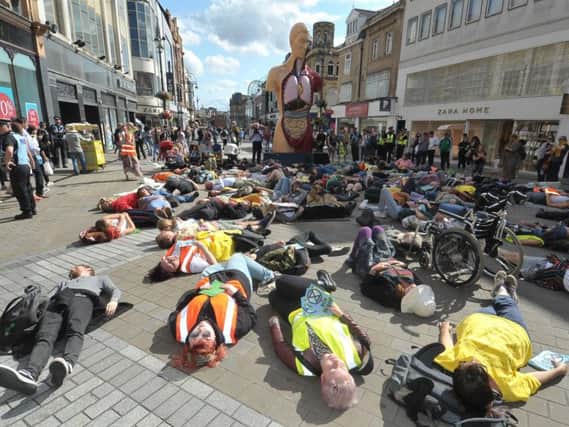 Extinction Rebellion protesters staging a mass 'die-in' on Briggate.