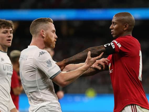 LATE CHECK: On Adam Forshaw, left, after a rash challenge from Manchester United's Ashley Young, right, in Wednesday's friendly. Photo by Paul Kane/Getty Images.