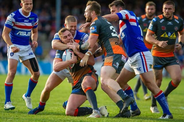 James Clare is tackled in Castleford Tigers' game at Wakefield Trinity. Picture: James Heaton