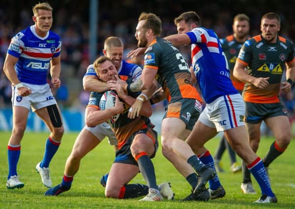 James Clare is tackled in Castleford Tigers' game at Wakefield Trinity. Picture: James Heaton