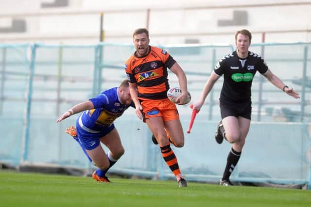 Castleford Tigers' James Clare is tap tackled by Leeds Rhinos' Brad Singleton. Picture Tony Johnson.