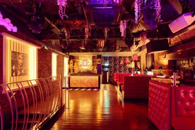 Hot pink and a botanical theme in the upstairs lounge at Dollhouse.