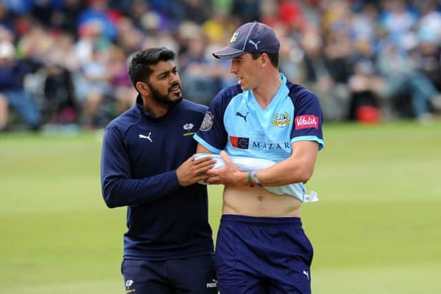 Big blow:
Yorkshire's Matthew Fisher leaves the pitch after injuring his shoulder. Picture: Tony Johnson