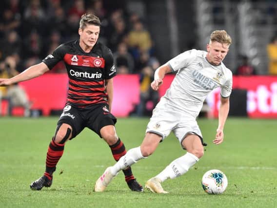 NEW STAR: Leeds United's Mateusz Bogusz fights for the ball with Permin Schwegler of Western Sydney Wanderers. Photo by Peter Parks/AFP/Getty Images.