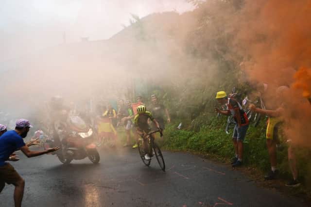 Great Britain's Simon Yates leads the race as as smoke from fans billows during the 15th stage of the Tour de France. Picture: Anne-Christine Poujoulat/Getty Images)