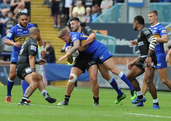 Leeds Rhinos' Liam Sutcliffe is tackled by Hull FC's Jake Connor. Picture: Tony Johnson.
