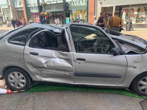 The smashed up car on Briggate, part of the Leeds Jurassic Trail.