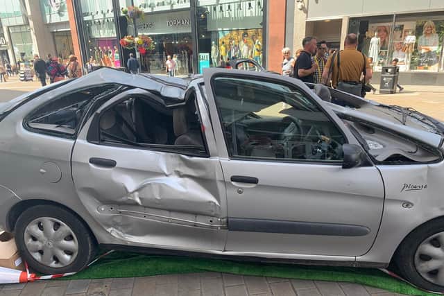 The smashed up car on Briggate, part of the Leeds Jurassic Trail.