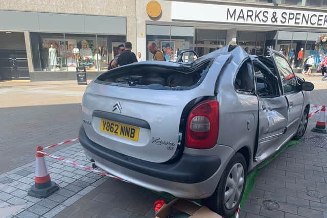 The smashed up car on Briggate, part of the Leeds Jurassic Trail.
