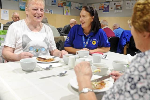 Dawn Newsome, chief executive at Armley Helping Hands, right, chats with Maureen Whelan at one of their ongoing activities - a supper club event, to combat social isolation for dozens of older people.
