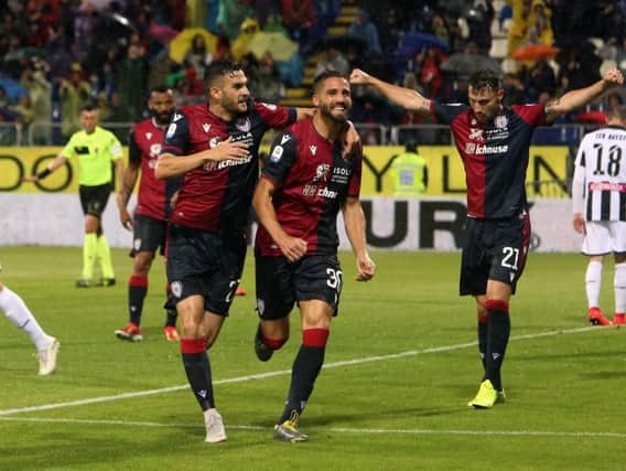 DANGER MAN: Cagliari Calcio's Italy international Leonardo Pavoletti, centre, celebrates his goal during the Serie A match between Cagliari and Udinese at Sardegna Arena back in May. Photo by Enrico Locci/Getty Images.