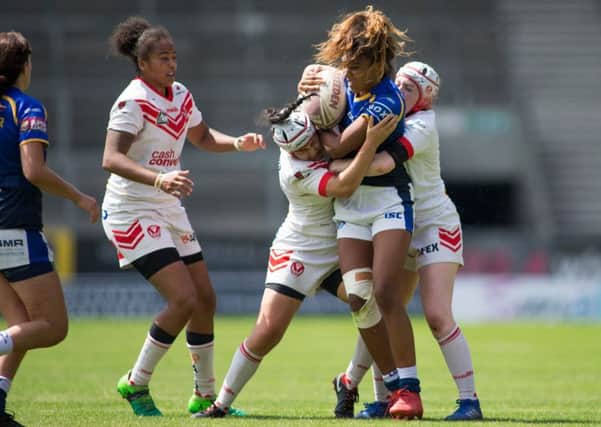Sophie Robinson of Leeds is tackled by Emily Rudge and Rhianna Burke of St Helens in the Challenge Cup semi-final.