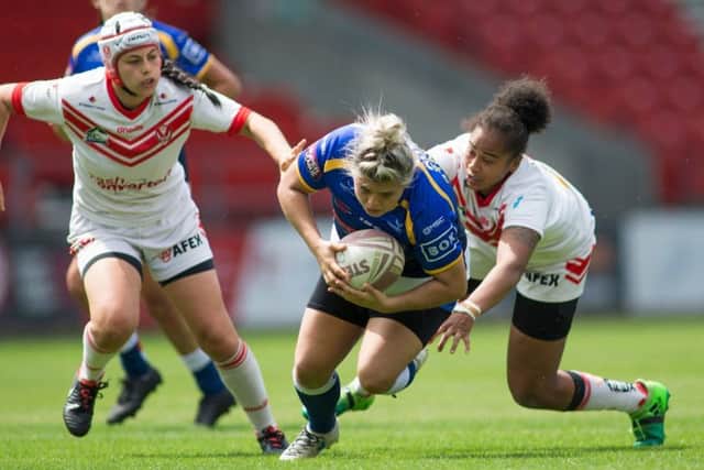Aimee Staveley of Leeds Rhinos is tackled by Channy Crowl of St Helens.