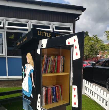 The Alice in Wonderland themed  Little Free Library outside Clapgate Primary School, Belle Isle where Carry Franklin taught.
