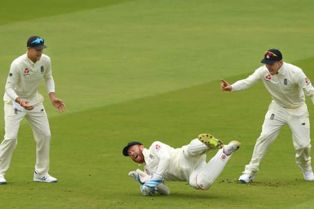 GOT HIM: England wicketkeeper Jonny Bairstow (c) celebrates with Joe Root and Jason Roy after catching William Porterfield out at Lord's. Picture: Stu Forster/Getty Images