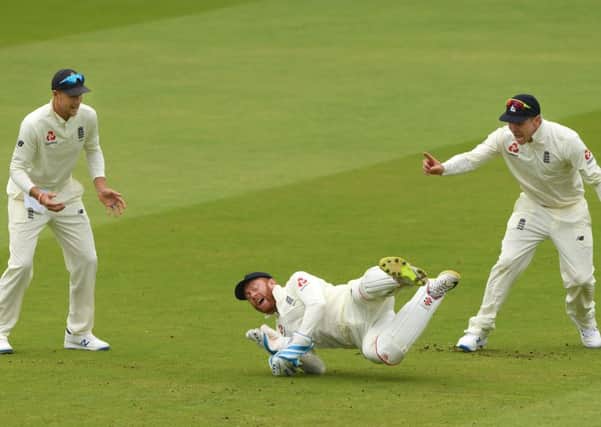 GOT HIM: England wicketkeeper Jonny Bairstow (c) celebrates with Joe Root and Jason Roy after catching William Porterfield out at Lord's. Picture: Stu Forster/Getty Images