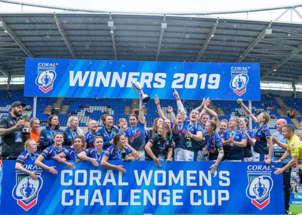 Leeds Rhinos' Courtney Hill, centre, lifts the Challenge Cup trophy after her side's 16-10 victory over Castleford Tigers.