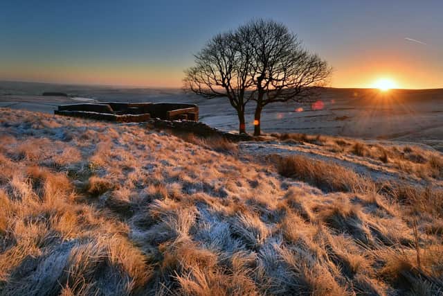 The Sun rises above a frosty Top Withens high in the Pennines above Haworth, the inspiration Wuthering Heights.