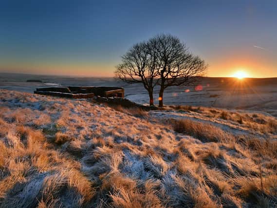 The Sun rises above a frosty Top Withens high in the Pennines above Haworth, the inspiration Wuthering Heights.