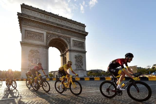 Competititors cycle past the iconic Arc de Triomphe in Paris on the last day of racing on Sunday. Picture: PA.
