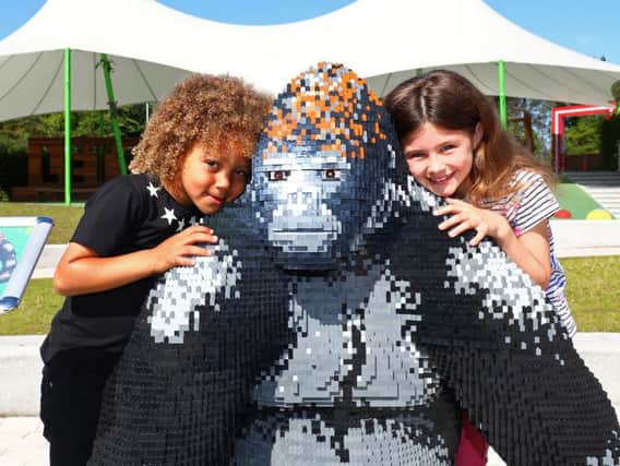Children enjoy the giant animal sculptures made of Lego