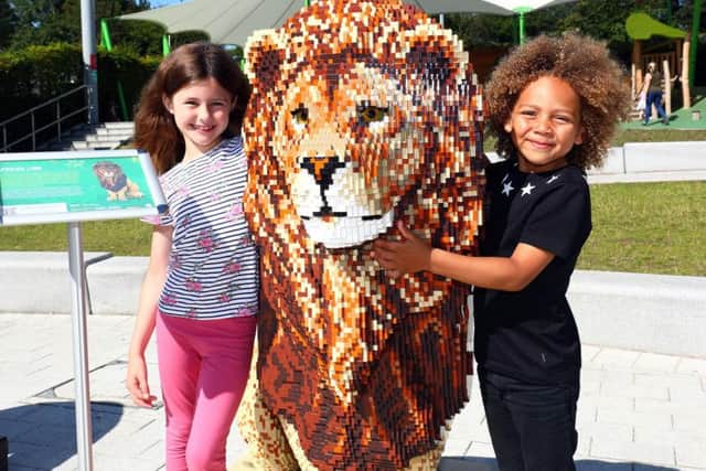 Children enjoy the giant animal sculptures made of Lego