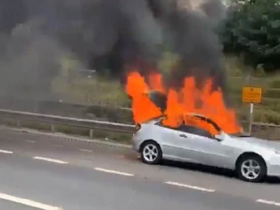 A car on fire on the M62 near Rothwell, Leeds
