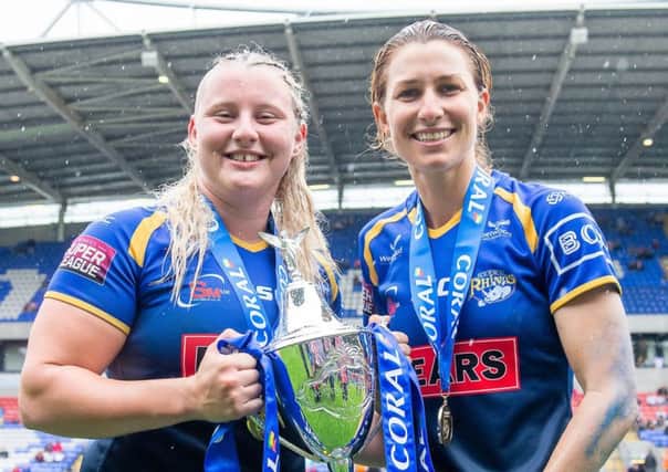 Leeds Rhinos' Charlotte Booth and Courtney Hill with the Coral Women's Challenge Cup trophy after victory over Castleford Tigers. PIC: Allan McKenzie/SWpix.com