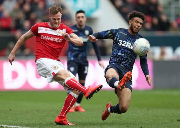 Bristol City's Tomas Kalas clears under pressure from Leeds United's Tyler Roberts.