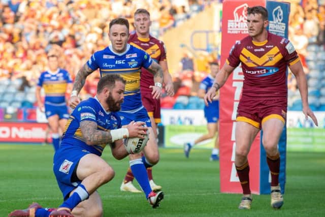 Adam Cuthbertson scores Rhinos' first try at Huddersfield.
