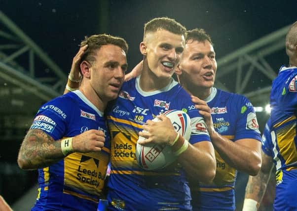 Leeds Rhinos players celebrate with Ash Handley after his second try on Friday.