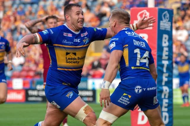 Brad Dwyer celebrates with Trent Merrin after scoring Leeds Rhinos' fourth try.