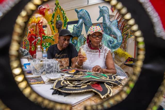 Arthur France, MBE, Chairman of The Leeds West Indian Carnival, chatting costume maker Yvette Smalle. Picture by James Hardisty.