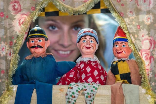 The Discovery Centre, Leeds, is showing a number of seaside exhibits part of the summer programme. Pictured Emily Nelson, Learning and Access Officer, at Leeds Discovery Centre, looking at an antique Punch and Judy puppet show. Picture: James Hardisty.