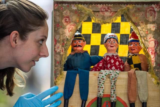 The Discovery Centre, Leeds, is showing a number of seaside exhibits part of the summer programme. Pictured Emily Nelson, Learning and Access Officer, at Leeds Discovery Centre, looking at an antique Punch and Judy puppet show. Picture: James Hardisty.